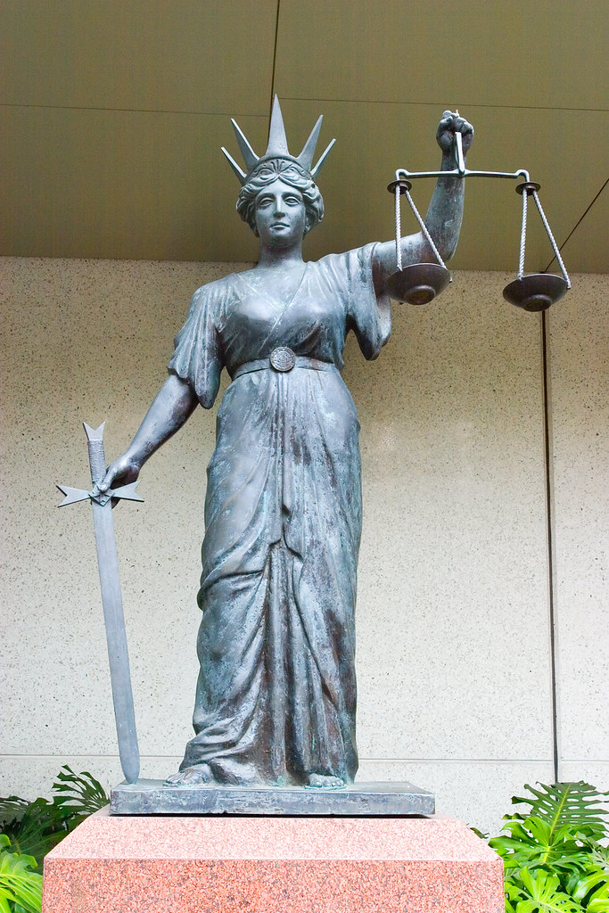 Scales of justice. Attribution: <p style="font-size: 0.9rem;font-style: italic;"><a href="https://www.flickr.com/photos/34534185@N00/114518457">"Scales of Justice Courts-1+"</a><span>by <a href="https://www.flickr.com/photos/34534185@N00">Sheba_Also 15.6 Million Views</a></span> is licensed under <a href="https://creativecommons.org/licenses/by-sa/2.0/?ref=ccsearch&atype=html" style="margin-right: 5px;">CC BY-SA 2.0</a><a href="https://creativecommons.org/licenses/by-sa/2.0/?ref=ccsearch&atype=html" target="_blank" rel="noopener noreferrer" style="display: inline-block;white-space: none;opacity: .7;margin-top: 2px;margin-left: 3px;height: 22px !important;"><img style="height: inherit;margin-right: 3px;display: inline-block;" src="https://search.creativecommons.org/static/img/cc_icon.svg" /><img style="height: inherit;margin-right: 3px;display: inline-block;" src="https://search.creativecommons.org/static/img/cc-by_icon.svg" /><img style="height: inherit;margin-right: 3px;display: inline-block;" src="https://search.creativecommons.org/static/img/cc-sa_icon.svg" /></a></p>